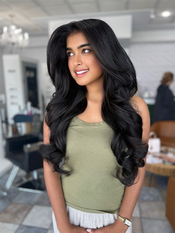 Long black blowout with big soft curls, styled at Social Salon
